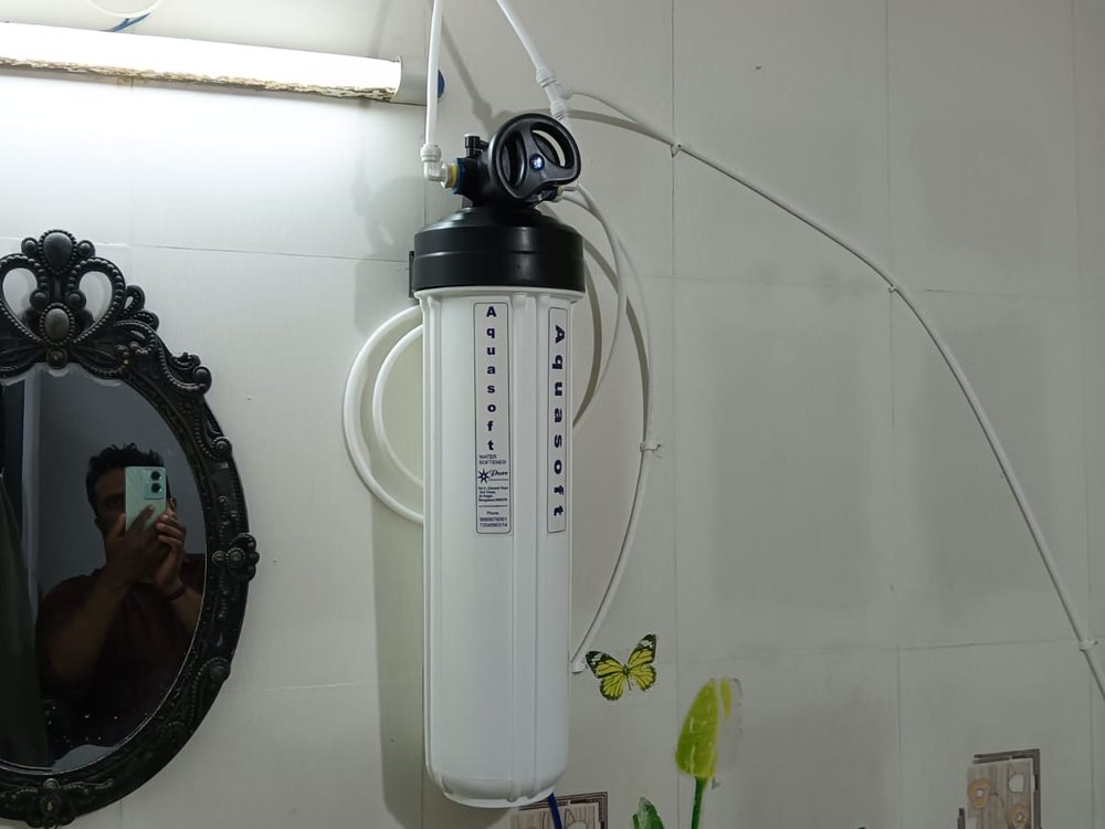 Compact RO unit mounted on tiled wall near sink
