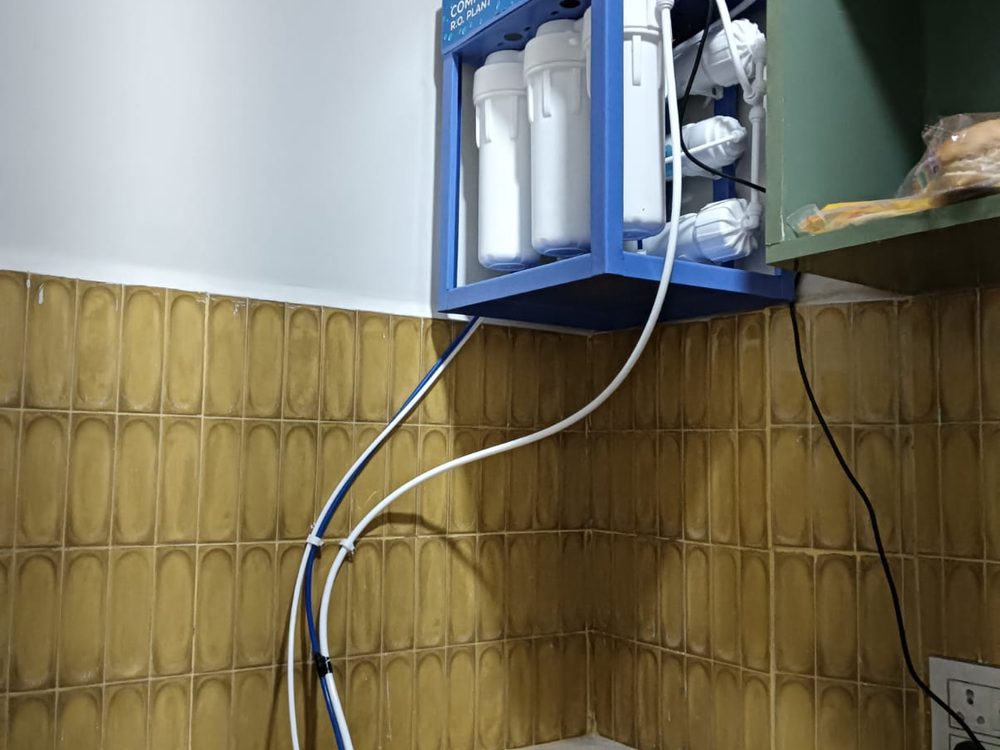RO purifier installed on bathroom wall with plumbing